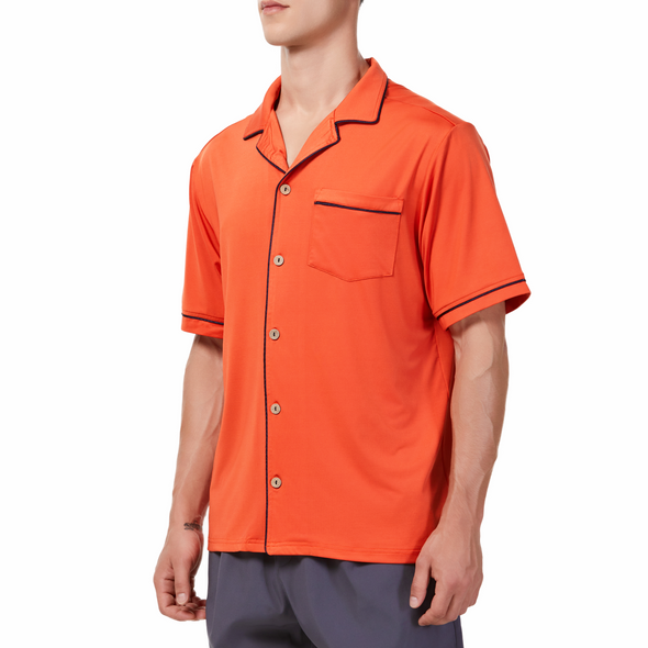 Men's Short sleeve orange camp shirt in a relaxed fit with a chest pocket made from knit fabric on a model - quarter view