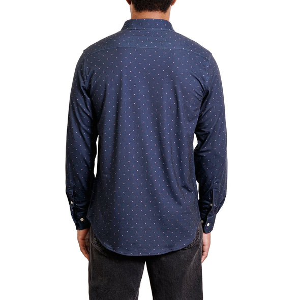 back view of a men's long sleeve, navy with light dots patterned button up knit dress shirt in cotton on a black model