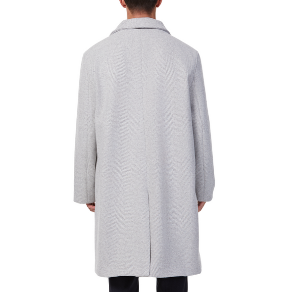 Men's long sleeve grey wool blend overcoat with double breasted front closure, large welt waist pockets and slightly oversized on a model - back view