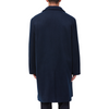 Men's long sleeve navy wool blend overcoat with double breasted front closure, large welt waist pockets and slightly oversized on a model - back view
