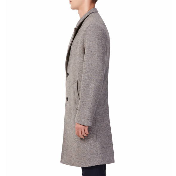 Men's long sleeve beige wool blend overcoat with 2 buttons at the front closer, large welt waist pockets and slightly oversized on a model - side view