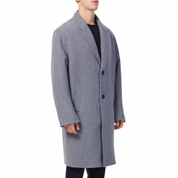 Men's long sleeve grey wool blend overcoat with 2 buttons at the front closer, large welt waist pockets and slightly oversized on a model - quarter view