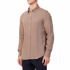 Men's brown linen long sleeve button up shirt with a pointed collar on a model. Image is cropped to the torso and model is facing  at side angle