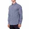 Men's  navy and white mini houndstooth patterned linen blend, long sleeve button up shirt with a pointed collar on a model. Image is cropped to the torso and model is angled to the models right