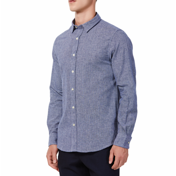 Men's  navy and white mini houndstooth patterned linen blend, long sleeve button up shirt with a pointed collar on a model. Image is cropped to the torso and model is angled to the models right
