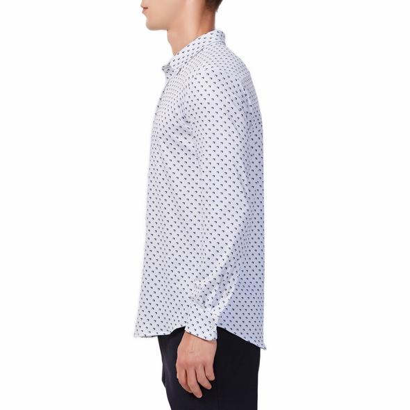Men's white button up shirt with a blue triangle stroke pattern all over, has long sleeves, button up front and pointed collar. made from knit fabric on a model - side view