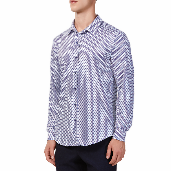 Men's white button up shirt with a navy honeycomb pattern all over, has long sleeves, button up front and pointed collar. made from knit fabric on a model - quarter view