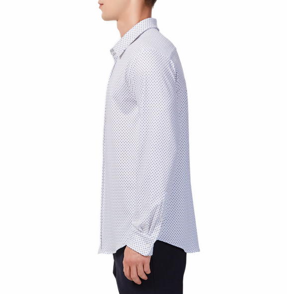 Men's white button up shirt with a dark blue dotted pattern all over, has long sleeves, button up front and pointed collar. made from knit fabric on a model - side view