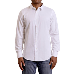 Three quarters side view of men's long sleeve, slim fit, classic white button up shirt on a black model. Organic cotton fabric has a small crosshatch pattern woven into it.