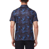Men's Short sleeve polo shirt in a blue and black allover palm frond print. Has a 3 button front colosure and pointed blue collar made from knit fabric on a model - back view