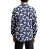 back view of a men's long sleeve, button up knit dress shirt in a white and navy floral print on a black model